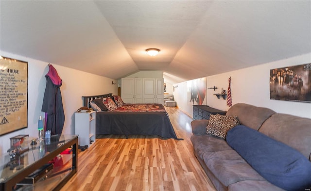 bedroom featuring a closet, lofted ceiling, and light hardwood / wood-style floors