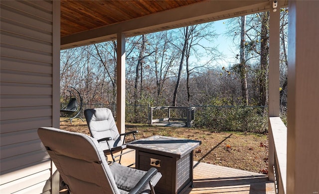 wooden terrace with an outdoor fire pit