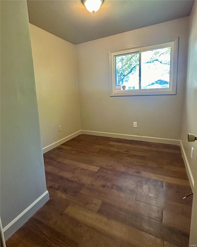 spare room featuring dark wood-type flooring