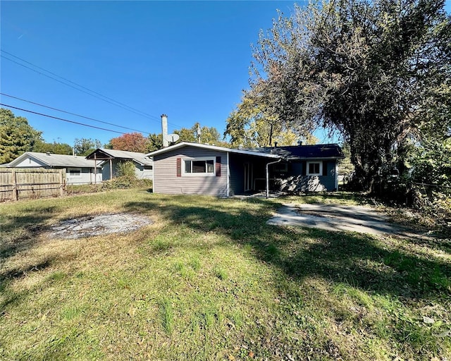 rear view of house with a lawn