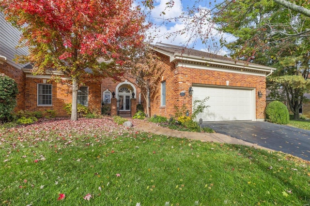 view of front of property with a front lawn and a garage