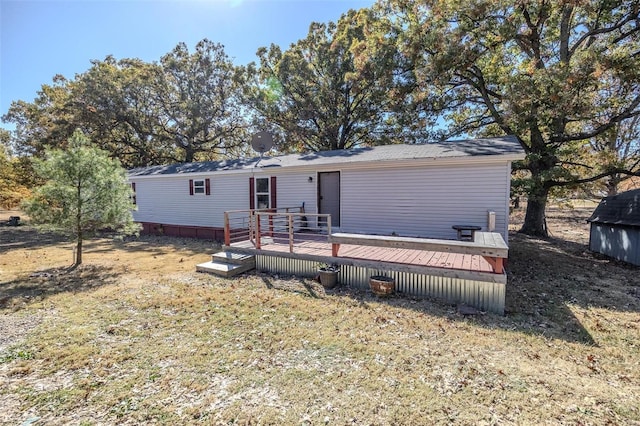 back of house featuring a yard and a wooden deck