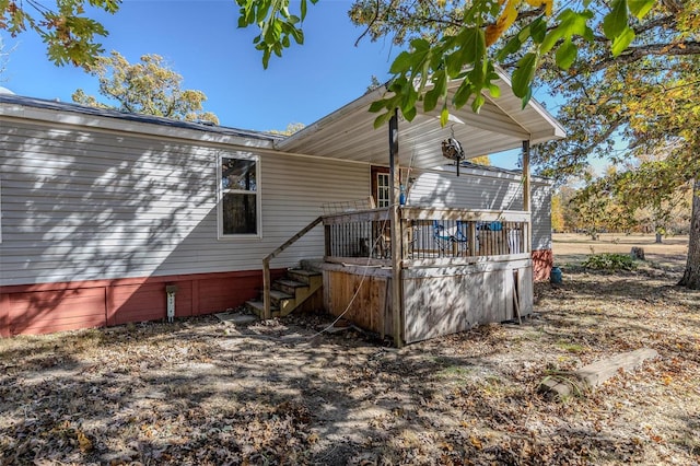 back of house with a deck