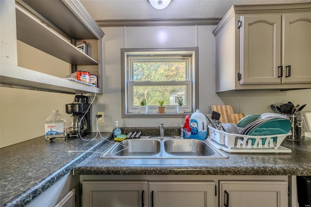 kitchen with sink, gray cabinetry, and a textured ceiling