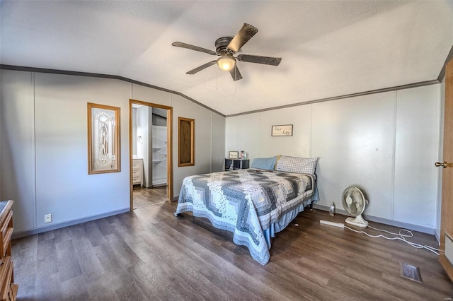 bedroom with ceiling fan, a textured ceiling, vaulted ceiling, dark hardwood / wood-style floors, and crown molding