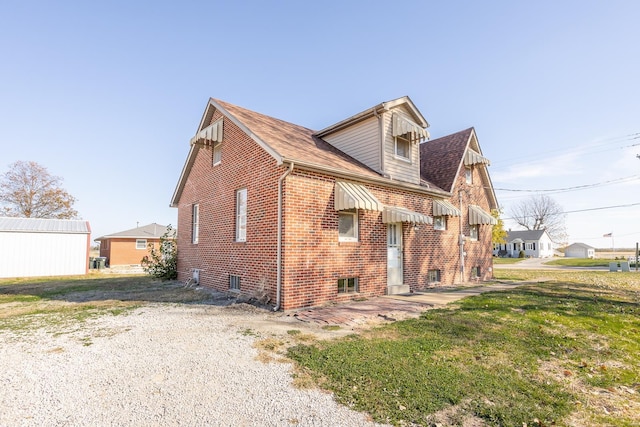 back of property featuring a lawn