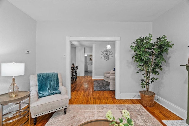 sitting room featuring baseboards and hardwood / wood-style floors