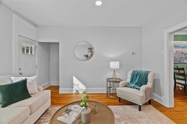 living room with baseboards and wood finished floors