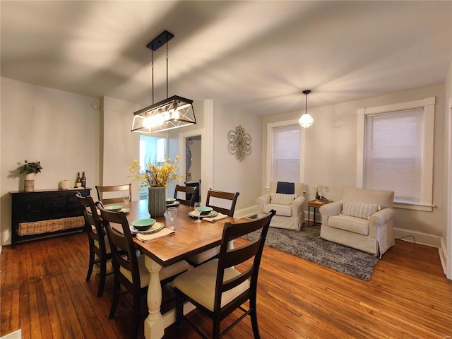 dining room featuring dark wood-type flooring and baseboards