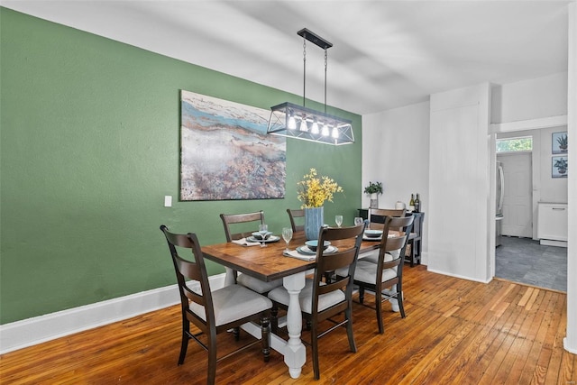 dining area featuring baseboards and wood-type flooring