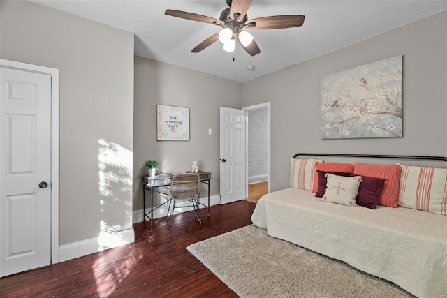 bedroom featuring ceiling fan, baseboards, and wood finished floors