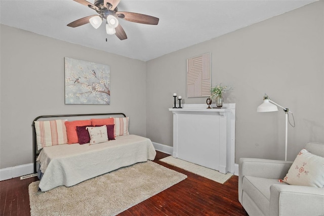 bedroom featuring a ceiling fan, wood finished floors, and baseboards