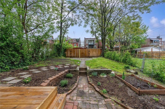 view of yard with a vegetable garden and fence