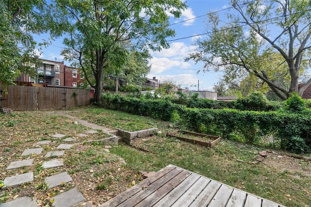 view of yard with a vegetable garden and fence