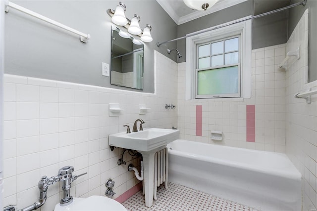 bathroom with ornamental molding, toilet, tile patterned floors, tile walls, and tiled shower / bath combo