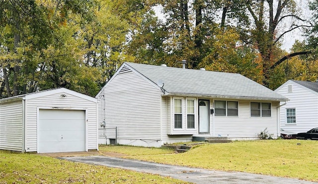 view of front facade featuring an outbuilding, a front lawn, and a garage