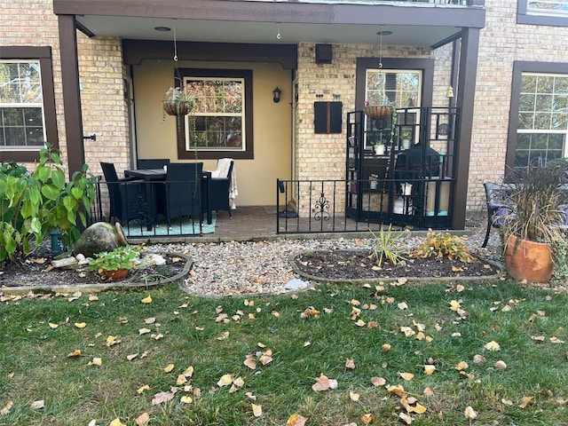 property entrance featuring a patio and a yard