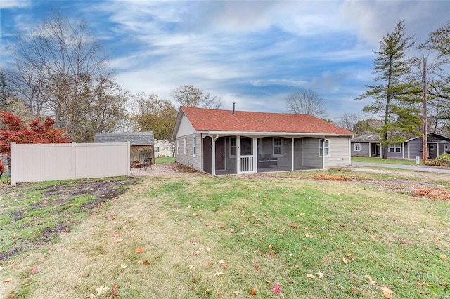 rear view of house with a sunroom and a lawn