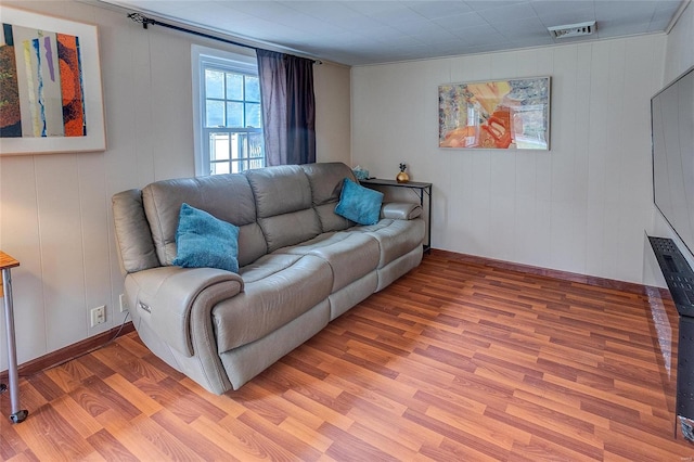 living room featuring ornamental molding and hardwood / wood-style floors