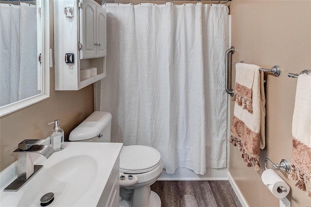 full bathroom with vanity, hardwood / wood-style flooring, shower / bath combo, and toilet