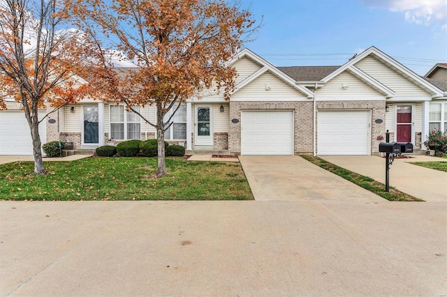 view of front of property with a front yard and a garage