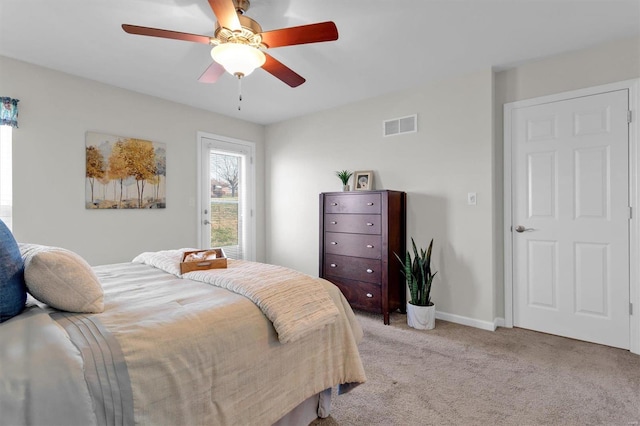 bedroom featuring light colored carpet and ceiling fan