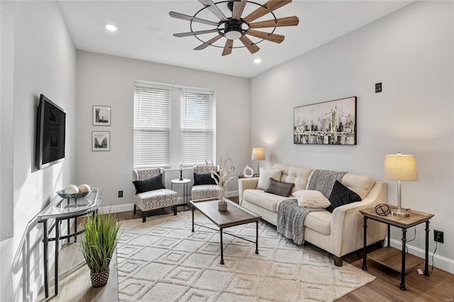 living room with light hardwood / wood-style floors and ceiling fan