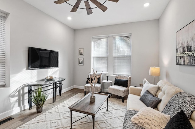 living room featuring ceiling fan and light wood-type flooring