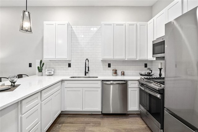 kitchen featuring white cabinets, stainless steel appliances, and hardwood / wood-style flooring