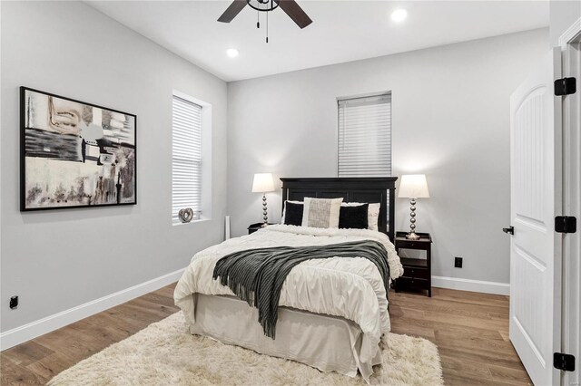 bedroom featuring light hardwood / wood-style floors and ceiling fan