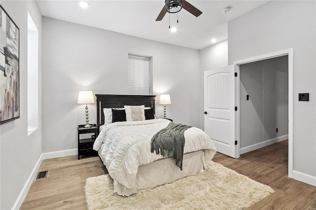 bedroom with light hardwood / wood-style floors and ceiling fan