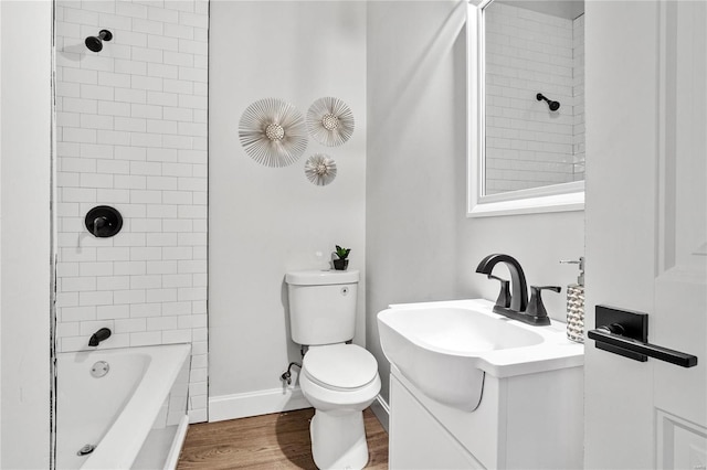 full bathroom featuring toilet, vanity, tiled shower / bath, and hardwood / wood-style flooring