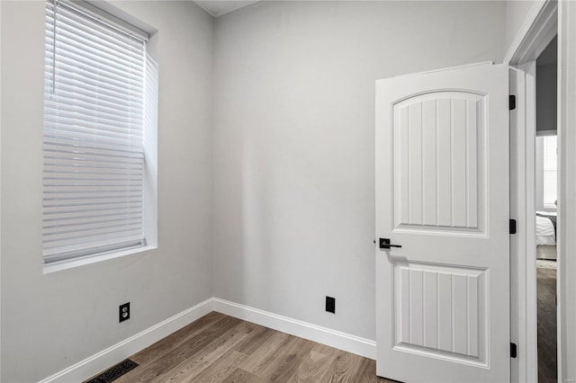 empty room with hardwood / wood-style floors