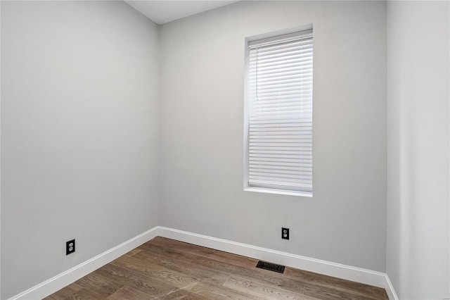 empty room with hardwood / wood-style flooring