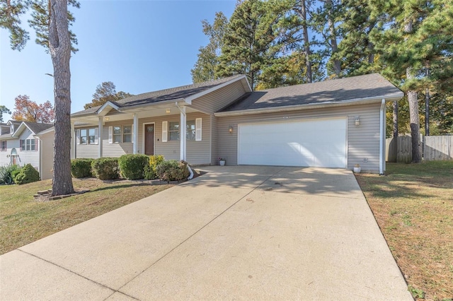 single story home with covered porch, a front yard, and a garage