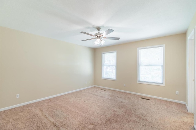 empty room featuring light carpet and ceiling fan