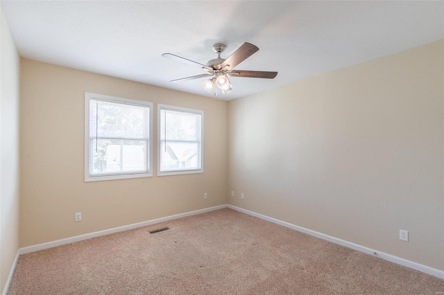 empty room with ceiling fan and carpet