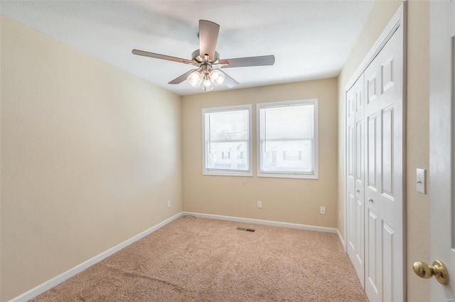 unfurnished bedroom with ceiling fan and carpet flooring