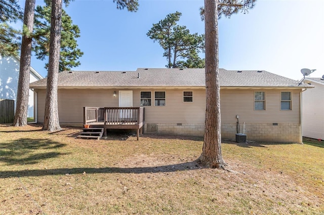 rear view of property with a wooden deck and a yard