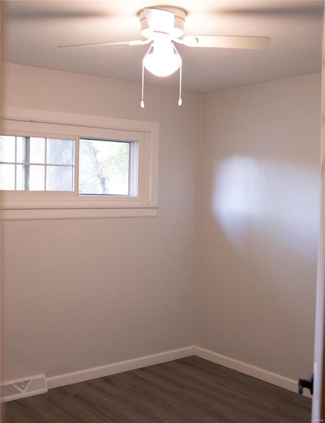 unfurnished room featuring dark hardwood / wood-style floors and ceiling fan