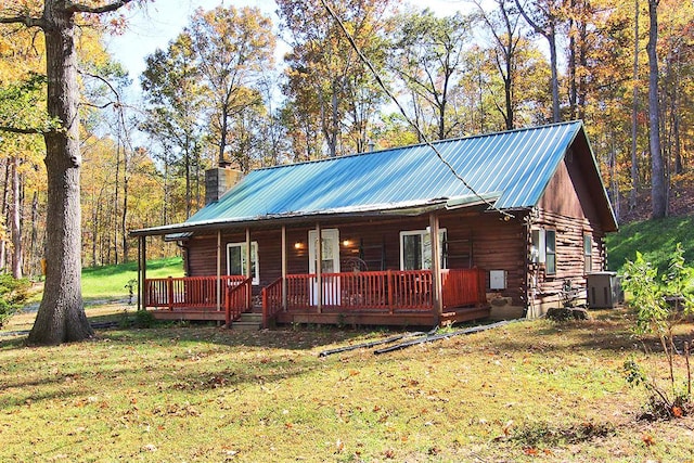 log home featuring central AC and a front yard