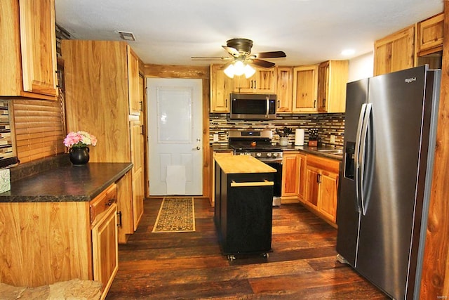 kitchen featuring appliances with stainless steel finishes, a center island, butcher block countertops, and dark hardwood / wood-style flooring