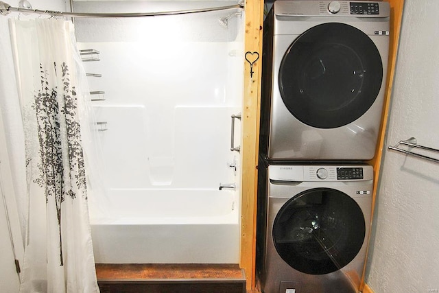 washroom with stacked washing maching and dryer