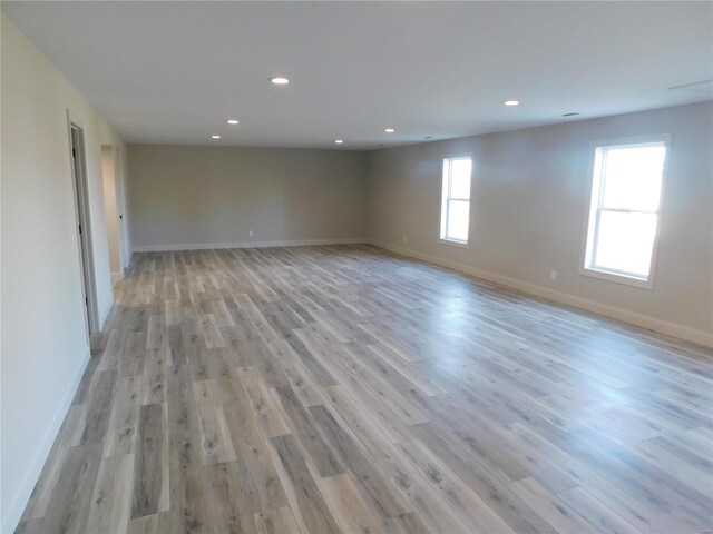 spare room with light wood-style floors, baseboards, and recessed lighting