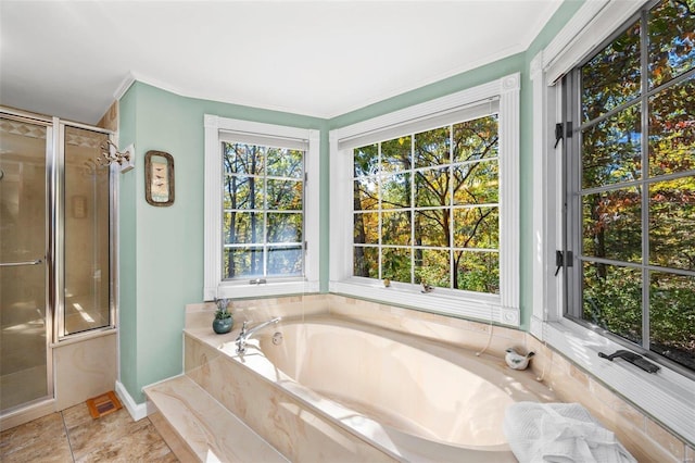 bathroom featuring independent shower and bath and ornamental molding