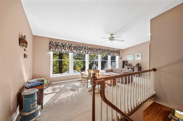 interior space featuring vaulted ceiling, carpet, and ceiling fan