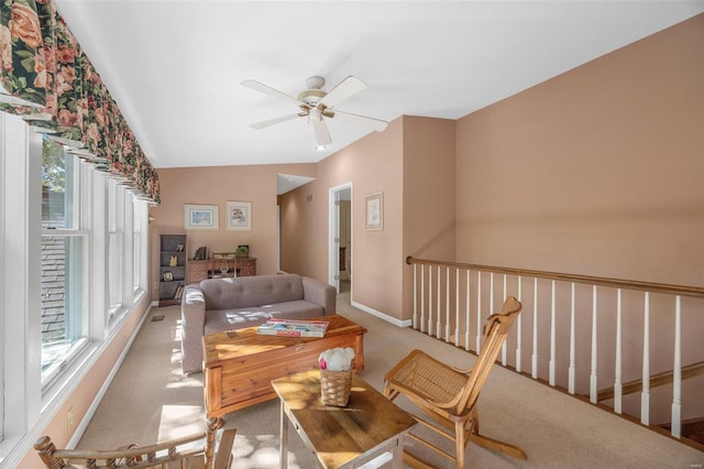 carpeted living room with vaulted ceiling and ceiling fan