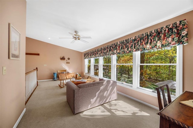 carpeted living room featuring ceiling fan and lofted ceiling