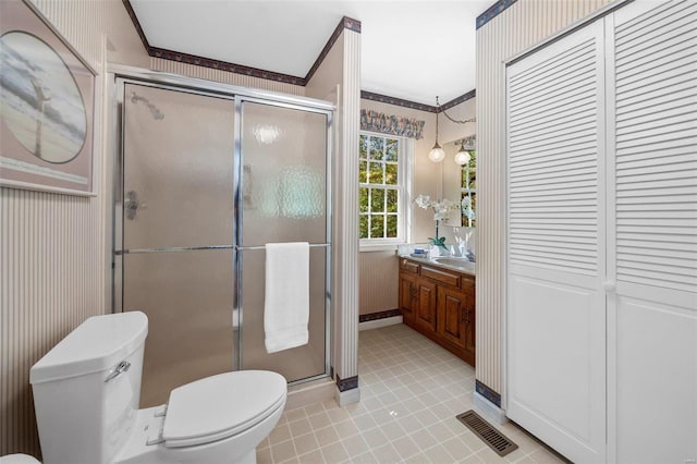 bathroom featuring walk in shower, vanity, toilet, and crown molding