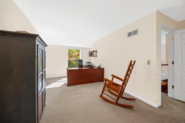 carpeted office space featuring lofted ceiling